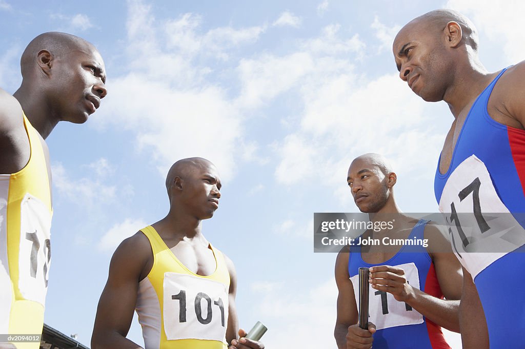 Four Rival Athletes Staring at Each Other