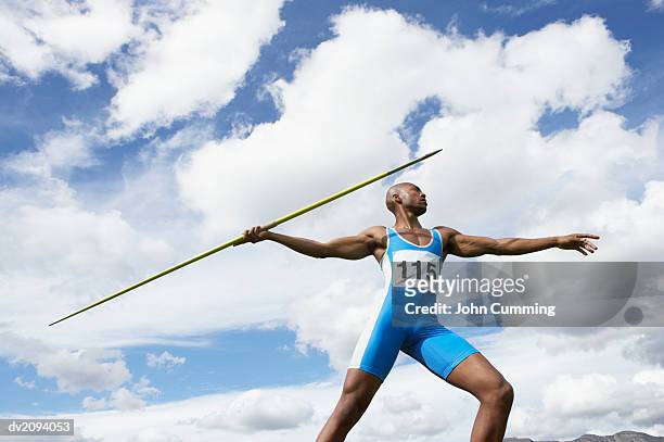 man throwing a javelin - sporthesje stockfoto's en -beelden