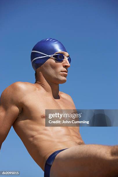 male swimmer sitting down - young men in speedos 個照片及圖片檔