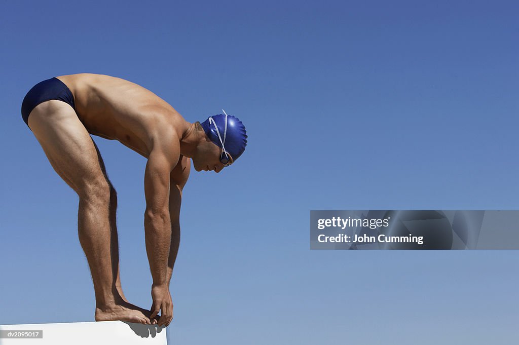 Male Swimmer About to Dive Into a Swimming Pool
