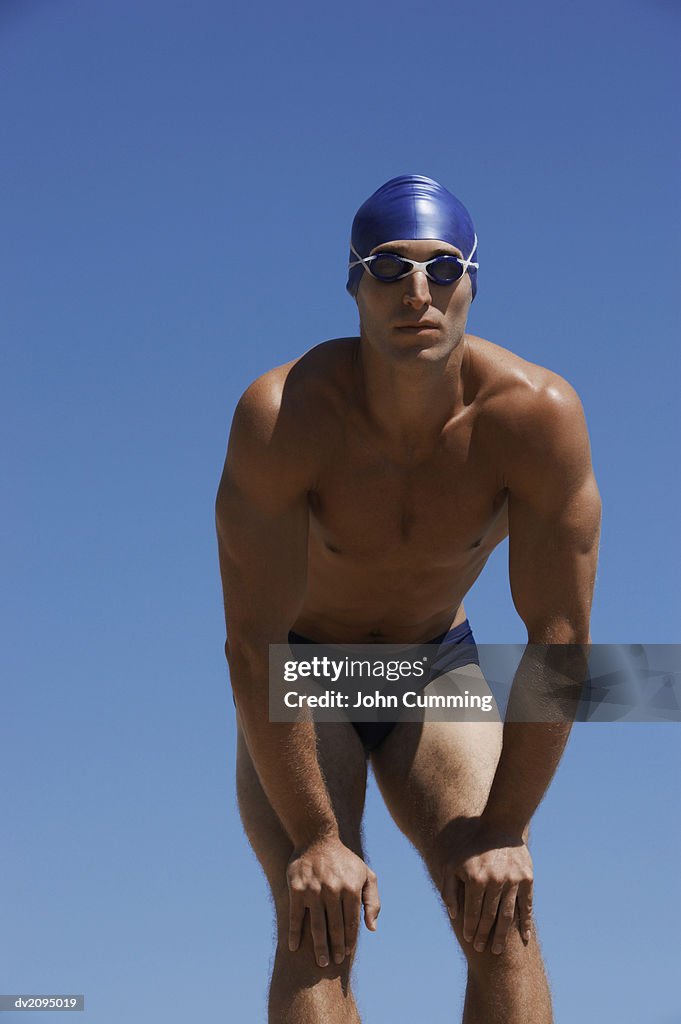 Male Swimmer With His Hands on His Knees