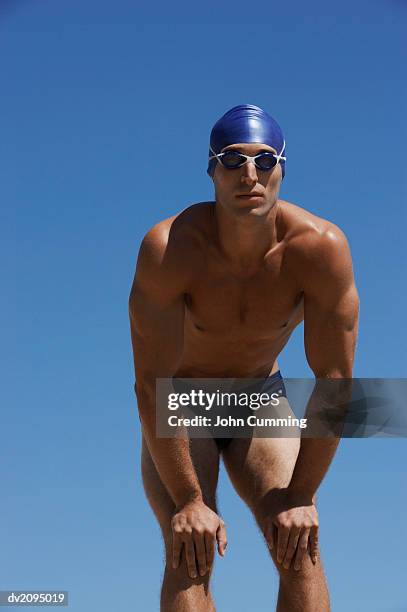 male swimmer with his hands on his knees - young men in speedos stock pictures, royalty-free photos & images