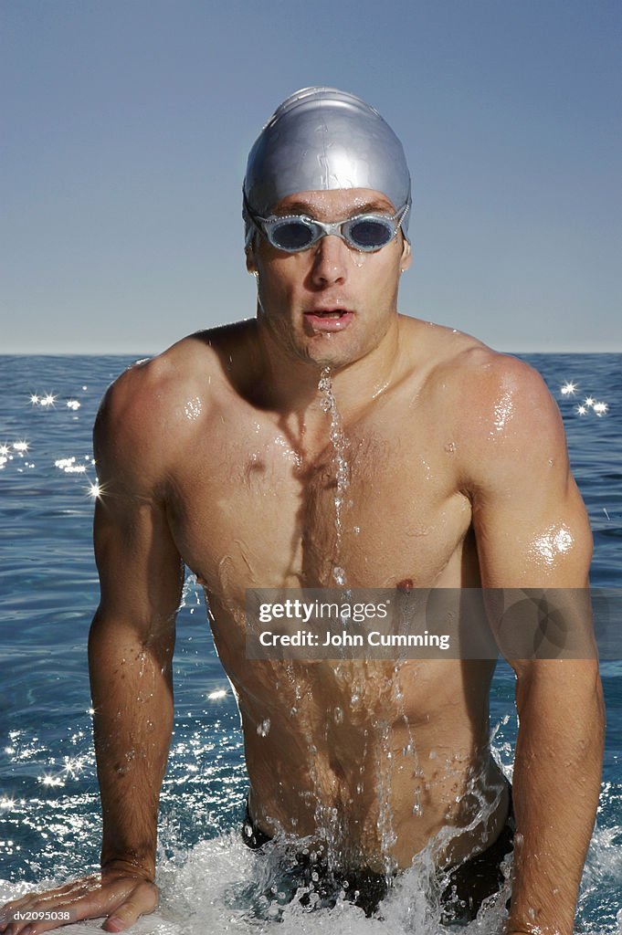 Man Pulling Himself Out of a Swimming Pool