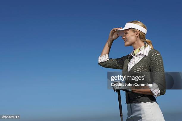 one female golf player looking ahead - ahead stock pictures, royalty-free photos & images