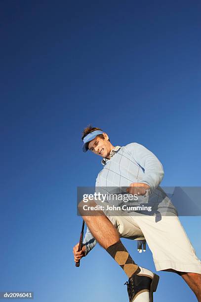 male golf player breaking a golf club with his knee - broken golf club stock pictures, royalty-free photos & images