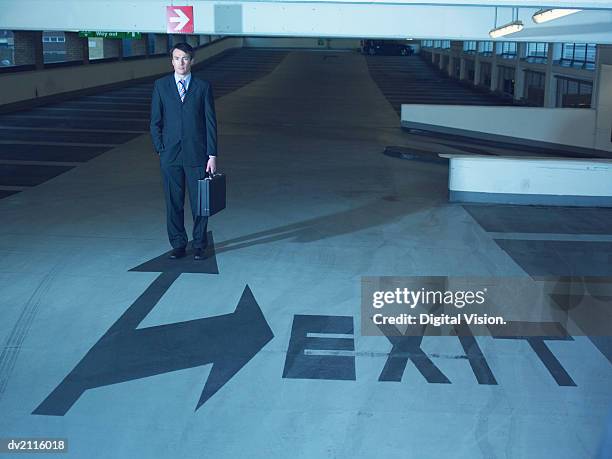 businessman in a car park - escrita ocidental imagens e fotografias de stock