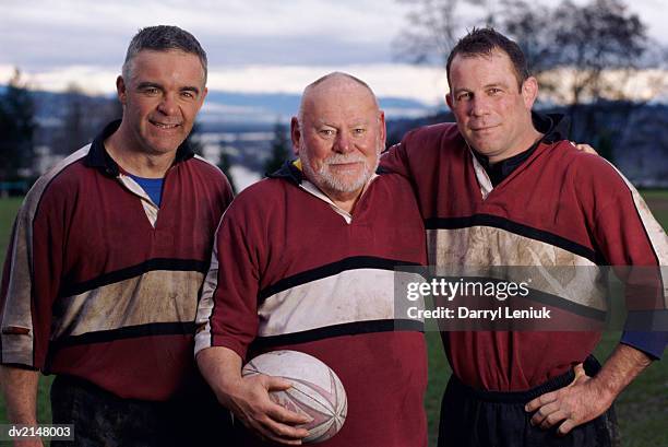 portrait of a three men with a rugby ball - rugbyhemd stock-fotos und bilder