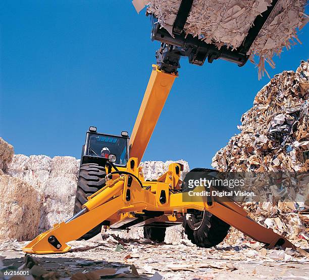 machine transporting paper at recycling center - center position stockfoto's en -beelden