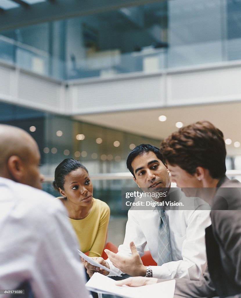 Business People Sitting in an Office Building Having a Meeting