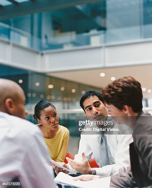 business people sitting in an office building having a meeting - digital collaboration ストックフォトと画像