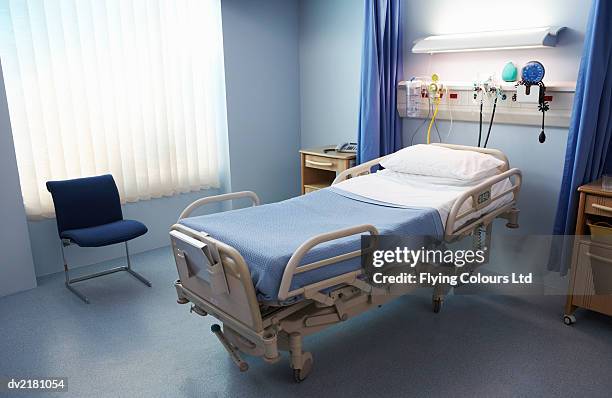 empty hospital bed in a ward - beds stock pictures, royalty-free photos & images