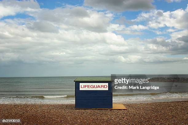 lifeguard hut on a beach at the water's edge - western script stock pictures, royalty-free photos & images