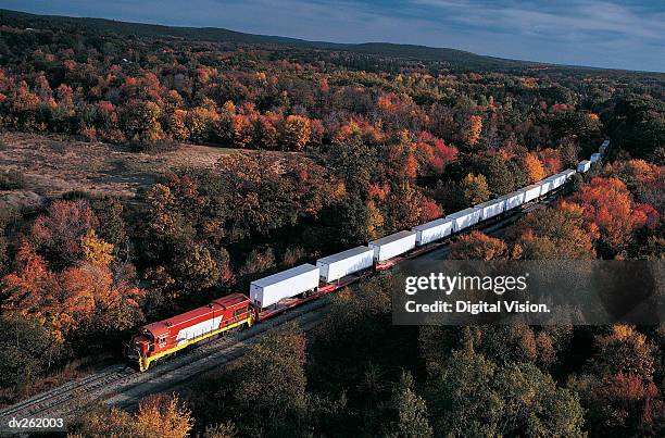 train traveling through countryside - comboio de mercadorias imagens e fotografias de stock