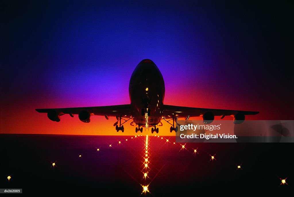 Plane lifting off from runway at dusk