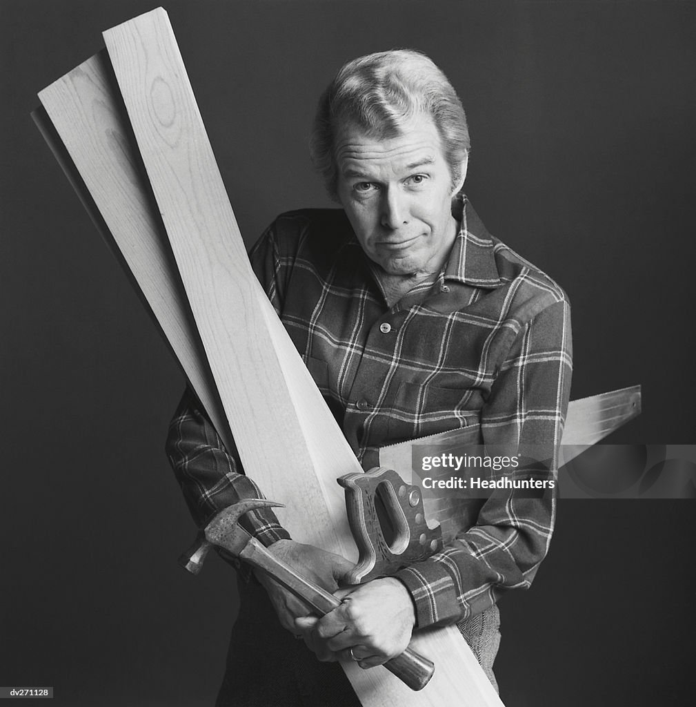 Carpenter with tools and boards