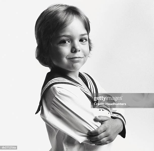 boy in sailor suit, arms crossed - headhunters stock-fotos und bilder