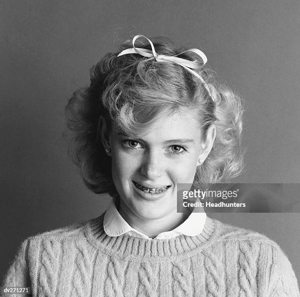 smiling girl with braces and ribbon in hair - headhunters stock pictures, royalty-free photos & images
