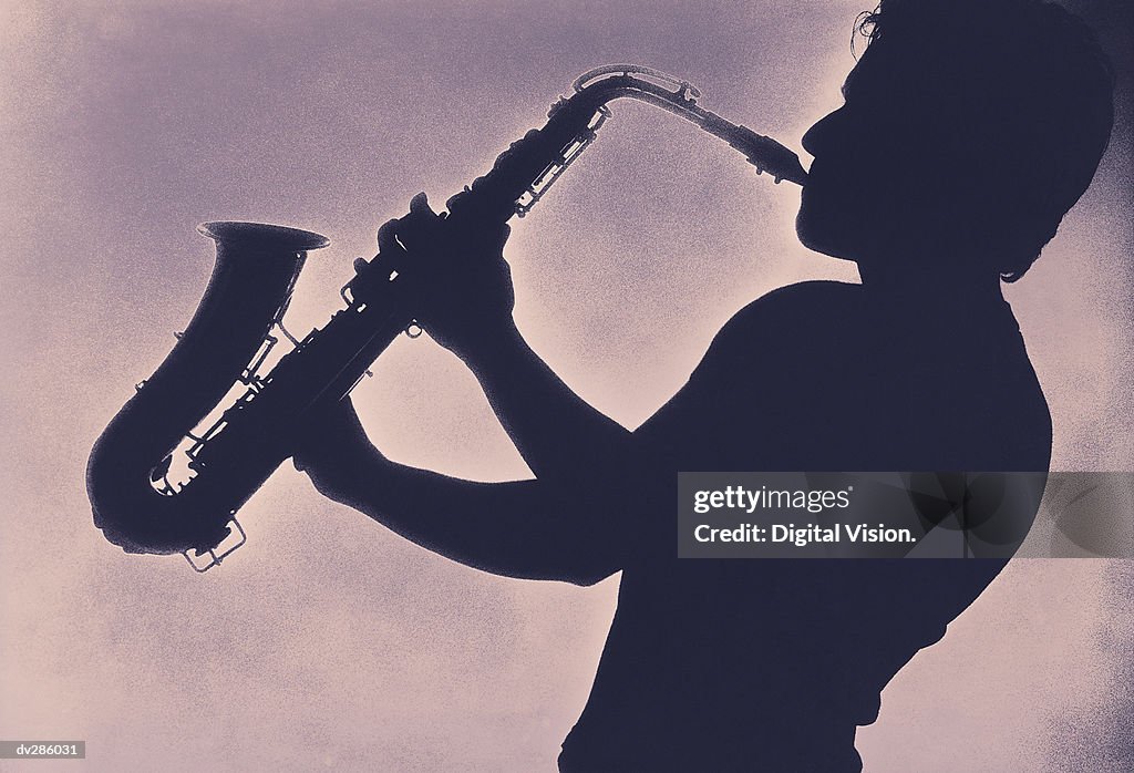 Profile of man playing saxophone