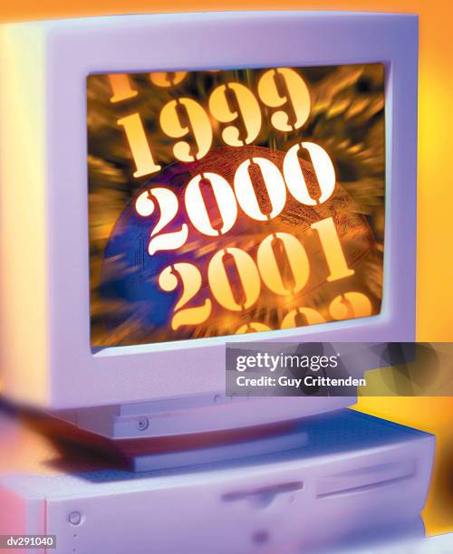 computer monitor showing glowing year 2000 in front of globe - 2000 technology stock pictures, royalty-free photos & images