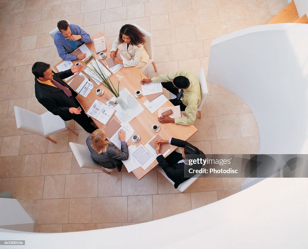 Looking down at professionals meeting at conference table