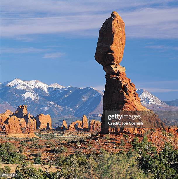 arches national park with mountainous background - balanced rock arches national park stock pictures, royalty-free photos & images