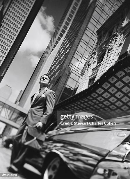 businessman standing next to vintage car - stewart stock-fotos und bilder