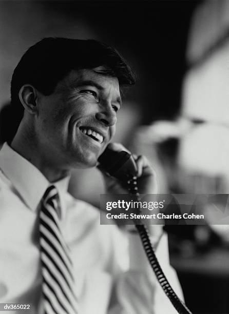 smiling businessman on telephone - stewart stock-fotos und bilder