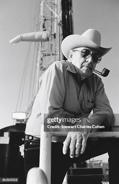 older man in front of oil well - stewart stock-fotos und bilder