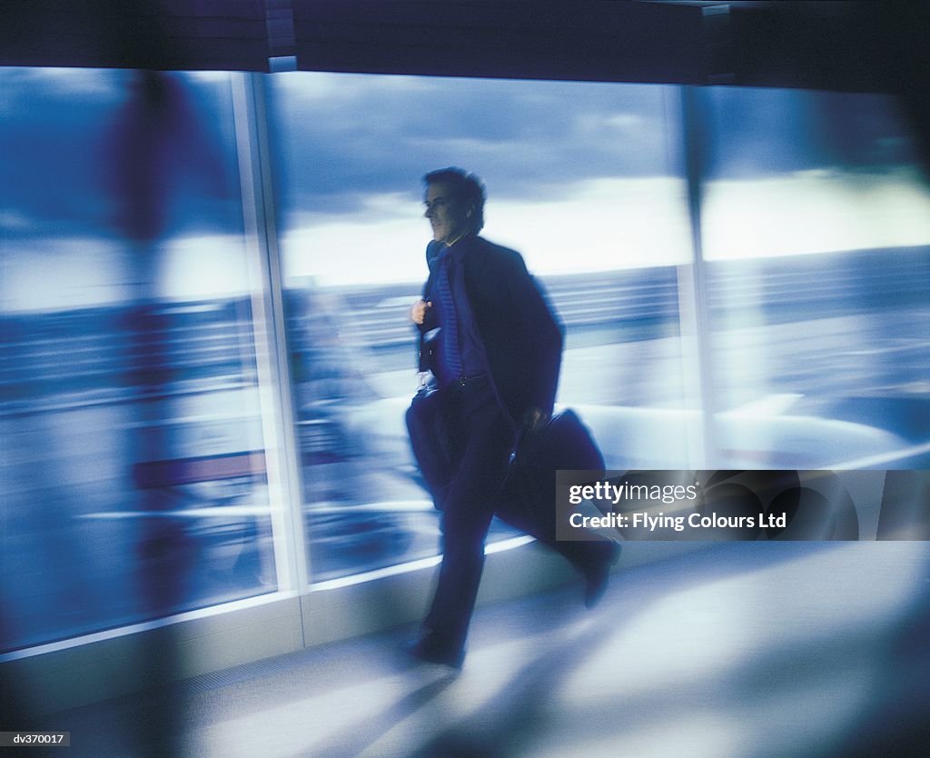 Businessman Rushing Businessman Rushing To Catch Plane High-Res Stock Photo - Getty Images