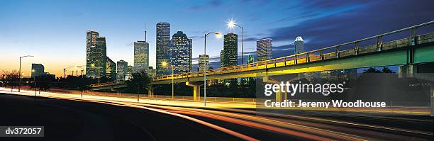 houston highway with city in background - houston texas night stock pictures, royalty-free photos & images