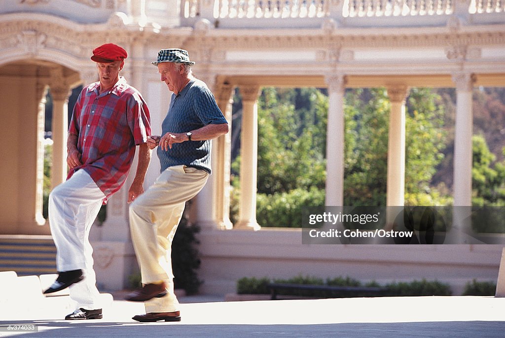Two elderly men dancing