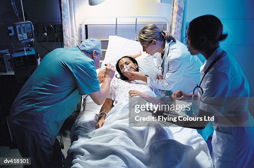 Doctor and nurses taking care of patient Doctor and nurses taking care of patient