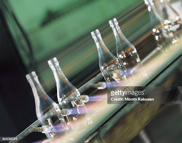 machine blowing glass into bottles - glass factory stock-fotos und bilder