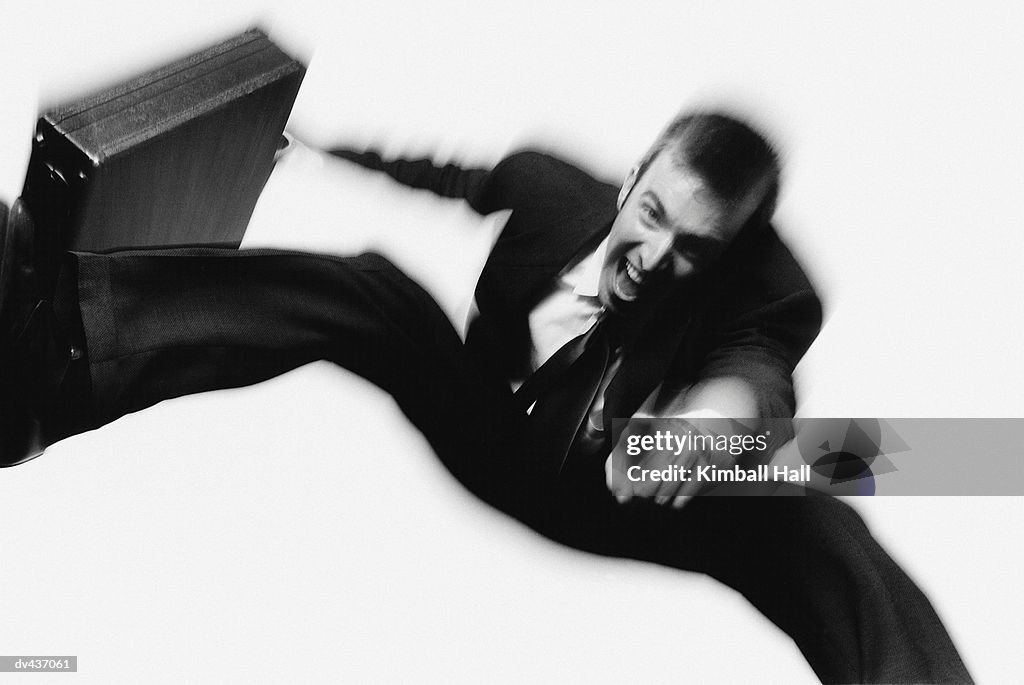 Businessman jumping and pointing in air