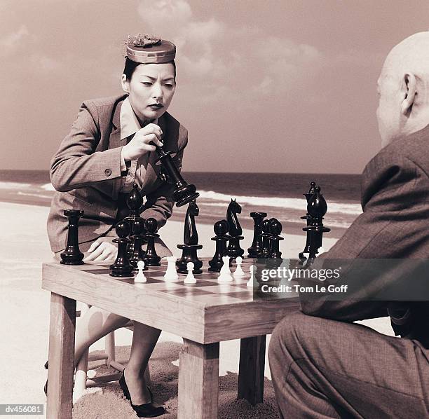 businesspeople playing chess at beach - pillbox hat stock pictures, royalty-free photos & images