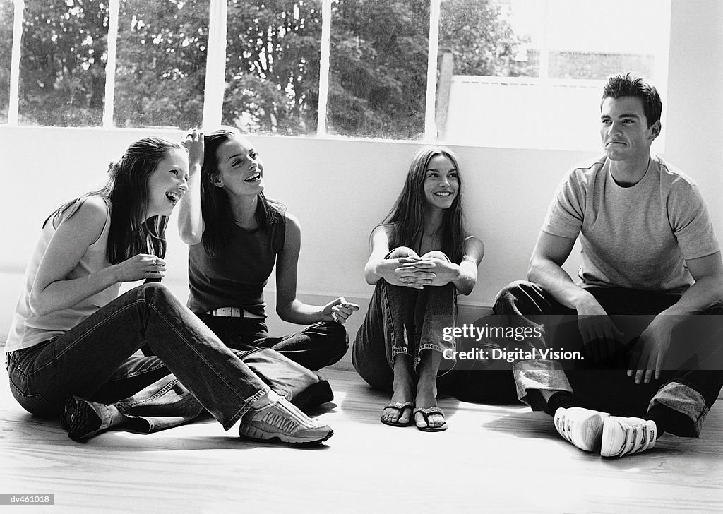 Group of young women and man, sitting together