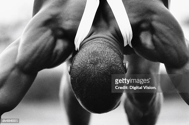 runner bending forward, stretching - forward athlete stock pictures, royalty-free photos & images