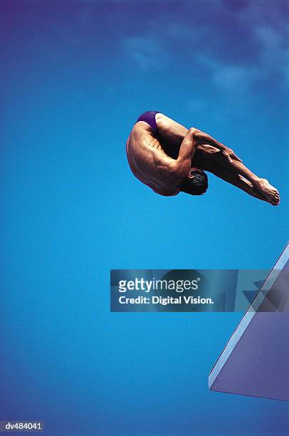 diver in pike position off of platform - pike position stock pictures, royalty-free photos & images