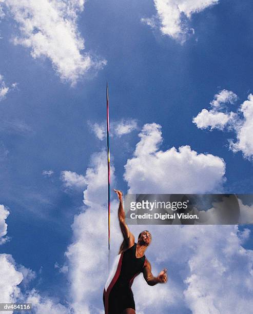 javelin thrower in front of dramatic clouds - saut et lancer d'athlétisme masculin photos et images de collection