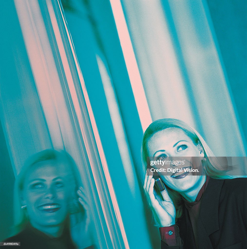 Businesswoman Using a Mobile Phone in a Car