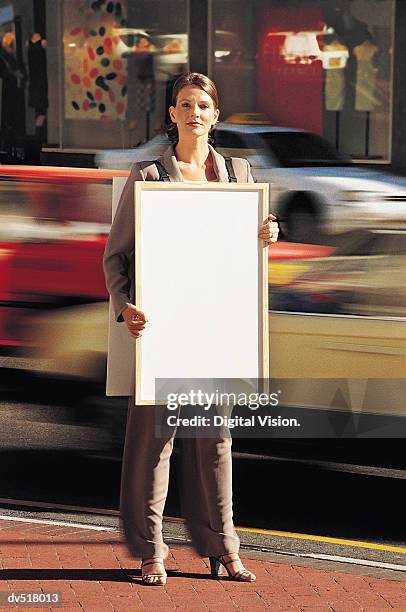 businesswoman holding blank paper - sandwich man stock-fotos und bilder