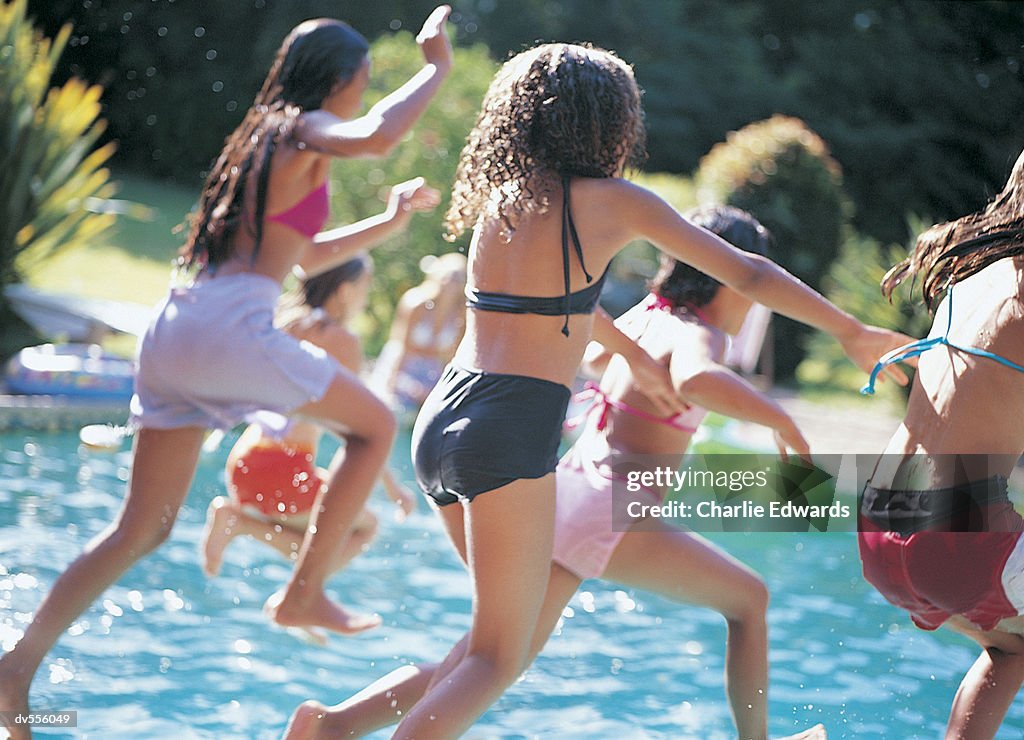 Children Jumping Into Swimming Pool
