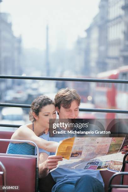 couple riding on double decker bus, london, england - decker stock pictures, royalty-free photos & images