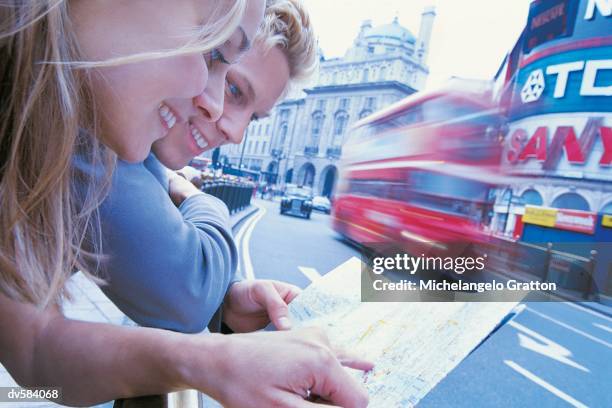 couple reading map, picadilly circus, london - london street map ストックフォトと画像