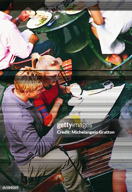 couple on cafe terrace, covent garden, london, england - the weekend in news around the world stock pictures, royalty-free photos & images