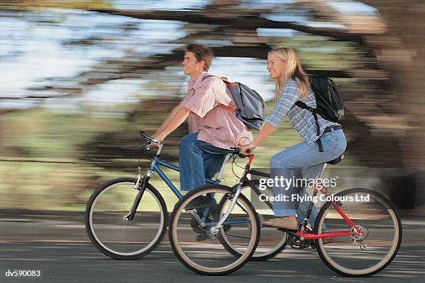 teenagers riding bikes - schwenk stock-fotos und bilder