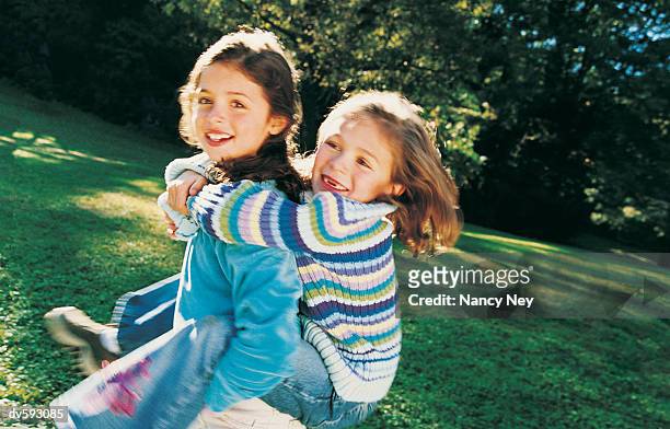young girls playing at the park - nancy green fotografías e imágenes de stock