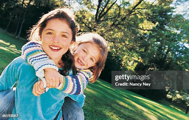 young girls playing at the park - nancy green stock-fotos und bilder