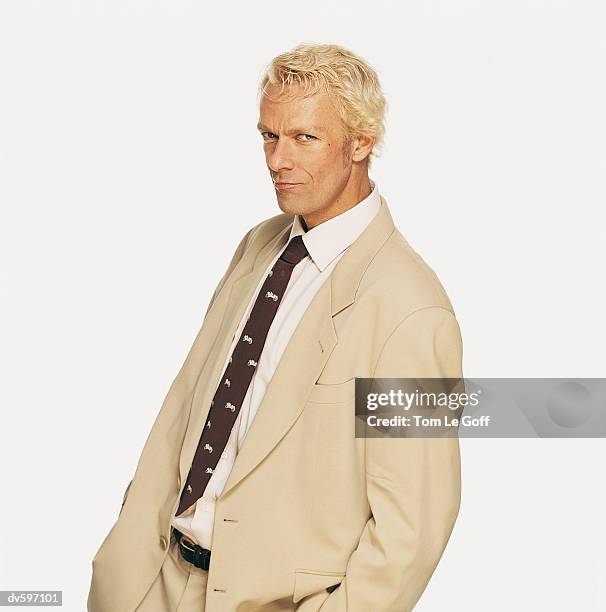 portrait of a blond man wearing a beige suit - le ストックフォトと画像