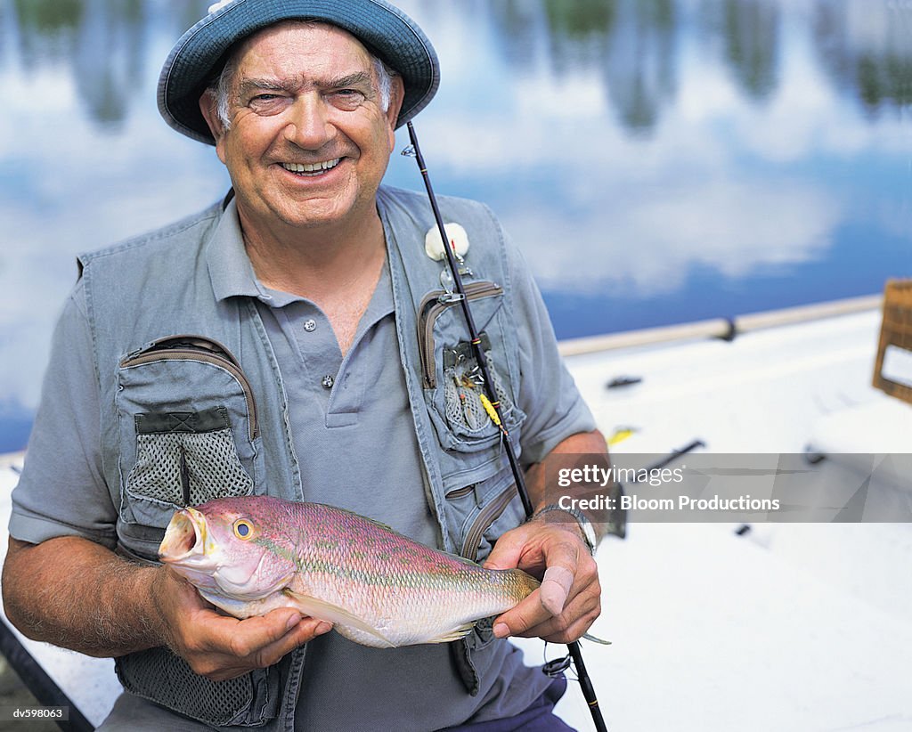 Mature Man Holding a Fish